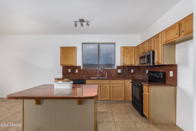 kitchen featuring light tile patterned floors, black range with electric stovetop, sink, decorative backsplash, and a breakfast bar