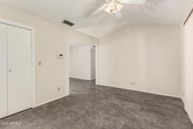 unfurnished bedroom featuring vaulted ceiling, a ceiling fan, and baseboards