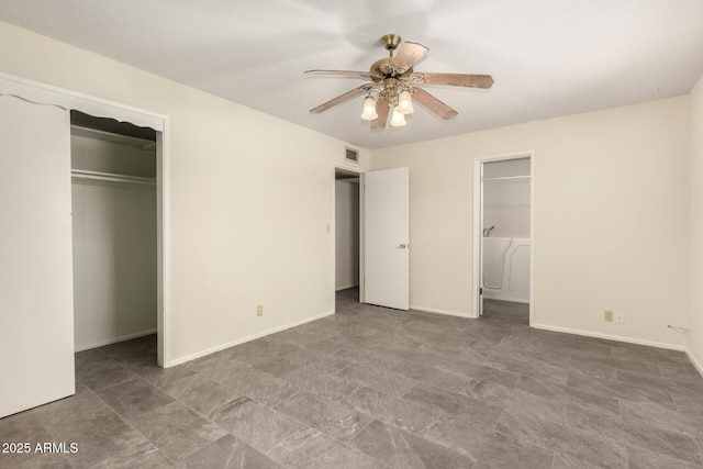 unfurnished bedroom with a closet, baseboards, a spacious closet, and ceiling fan