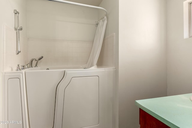 full bathroom with vanity, a tub to relax in, and curtained shower
