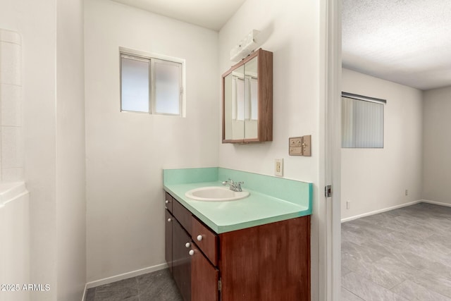 bathroom with vanity and baseboards