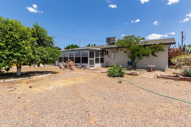 back of property featuring a sunroom and central AC unit