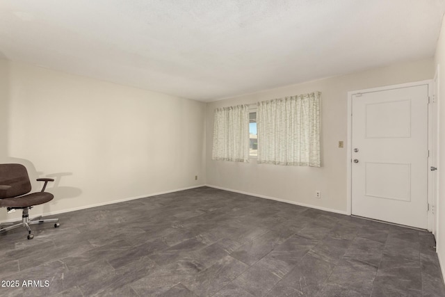 unfurnished living room featuring baseboards