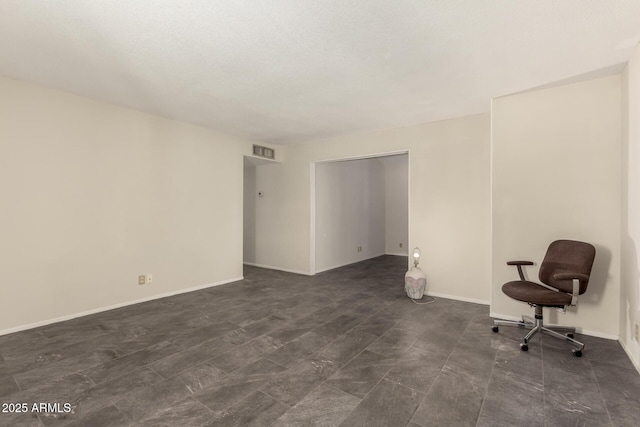 unfurnished room featuring baseboards