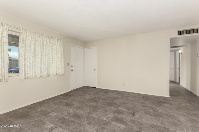 spare room featuring baseboards