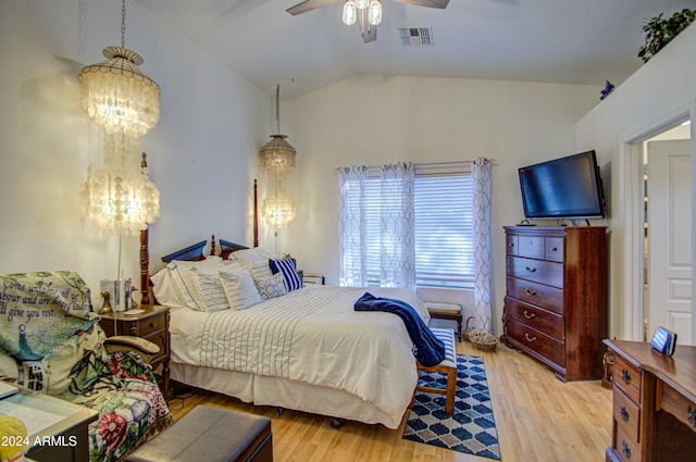 bedroom with light hardwood / wood-style flooring, vaulted ceiling, and ceiling fan