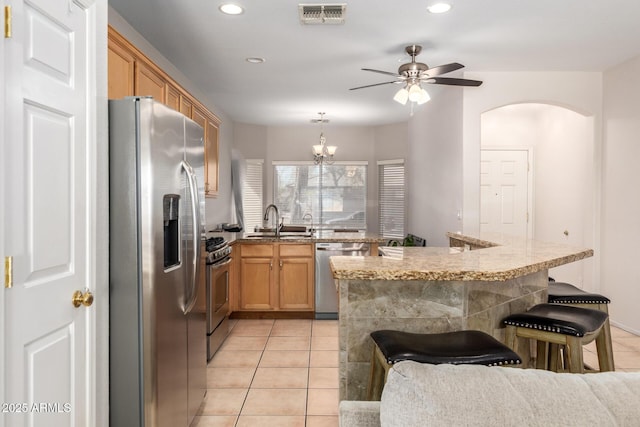 kitchen featuring stainless steel appliances, visible vents, a sink, and light tile patterned floors