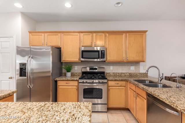 kitchen with stainless steel appliances, light tile patterned floors, a sink, and tasteful backsplash