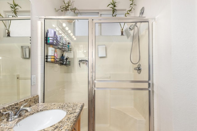 bathroom featuring a shower stall and vanity