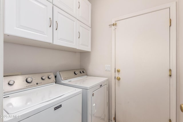 laundry room with independent washer and dryer and cabinet space