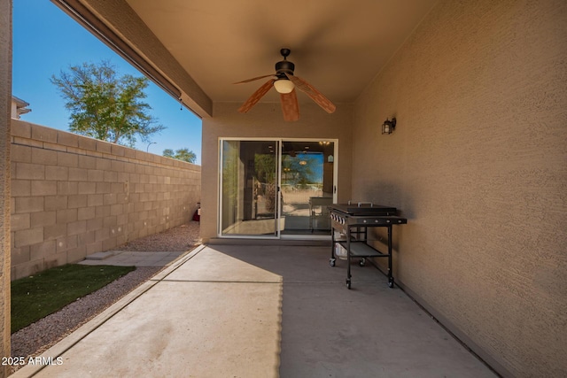 view of patio with a fenced backyard and a ceiling fan