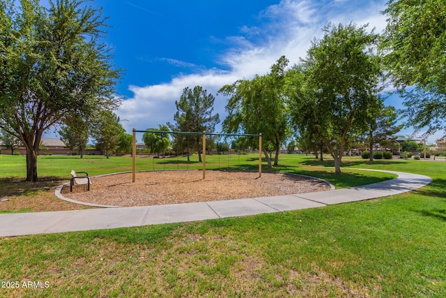 view of community featuring playground community and a yard