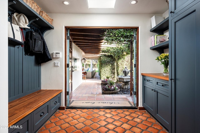 mudroom featuring dark tile patterned flooring