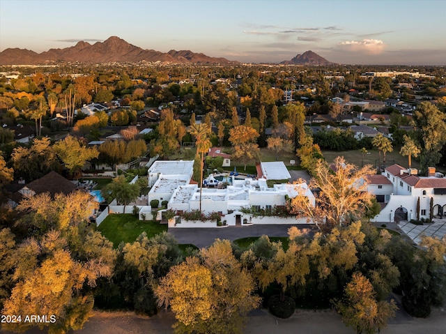 aerial view at dusk featuring a mountain view