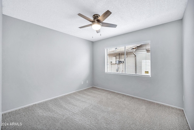 empty room with carpet, ceiling fan, and a textured ceiling