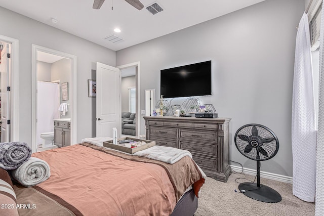 bedroom with ensuite bathroom, ceiling fan, and light carpet