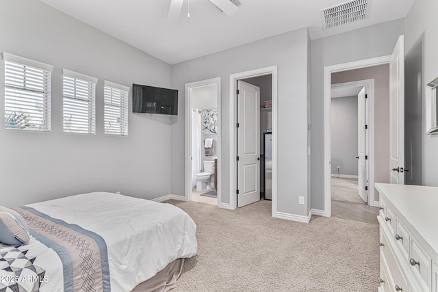 carpeted bedroom with ceiling fan and ensuite bath