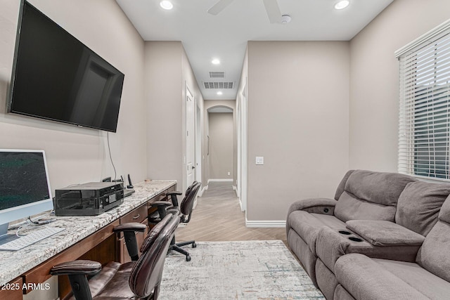 home office featuring ceiling fan and light hardwood / wood-style flooring