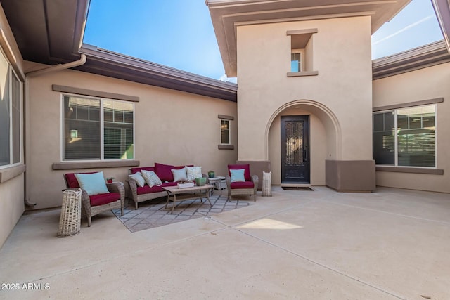 doorway to property with outdoor lounge area and a patio