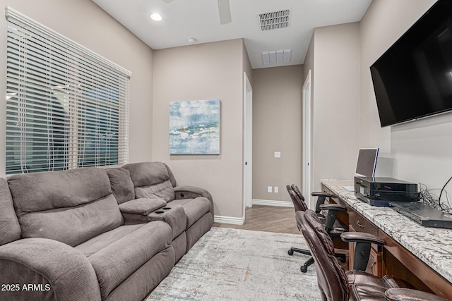 office space featuring ceiling fan and light hardwood / wood-style floors