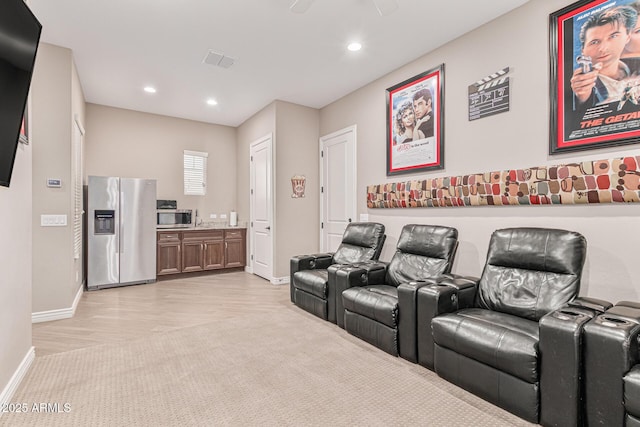 home theater with ceiling fan and light wood-type flooring