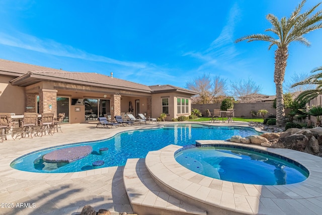 view of pool featuring an in ground hot tub and a patio