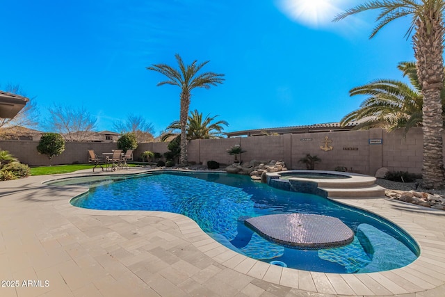 view of pool with an in ground hot tub and a patio