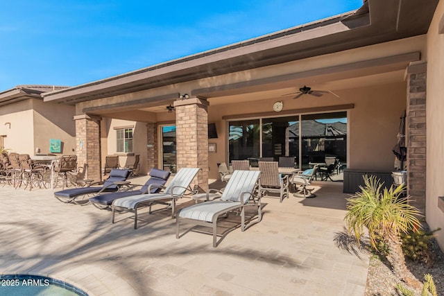 view of patio featuring ceiling fan