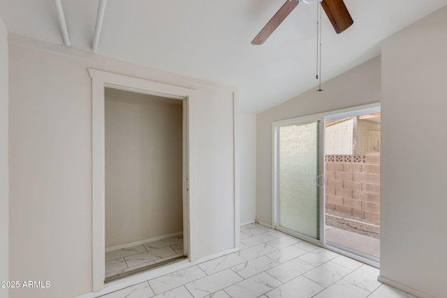 unfurnished room featuring marble finish floor, baseboards, a ceiling fan, and vaulted ceiling