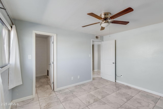 unfurnished bedroom featuring visible vents, baseboards, and a ceiling fan