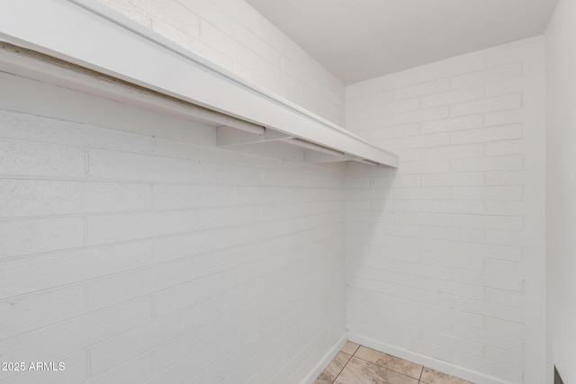 walk in closet featuring light tile patterned flooring