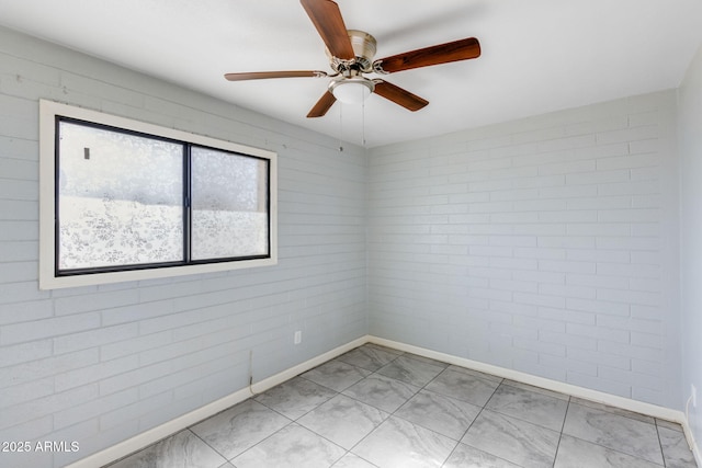 empty room with baseboards and a ceiling fan