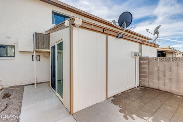 view of side of home with a patio