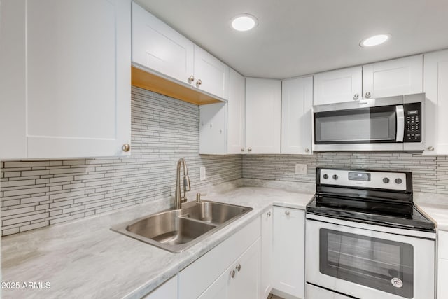 kitchen featuring a sink, light countertops, white cabinetry, and stainless steel appliances