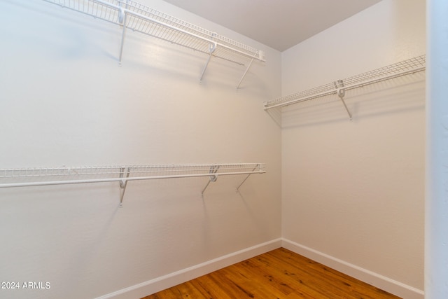 spacious closet featuring hardwood / wood-style floors