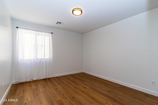 empty room with hardwood / wood-style flooring