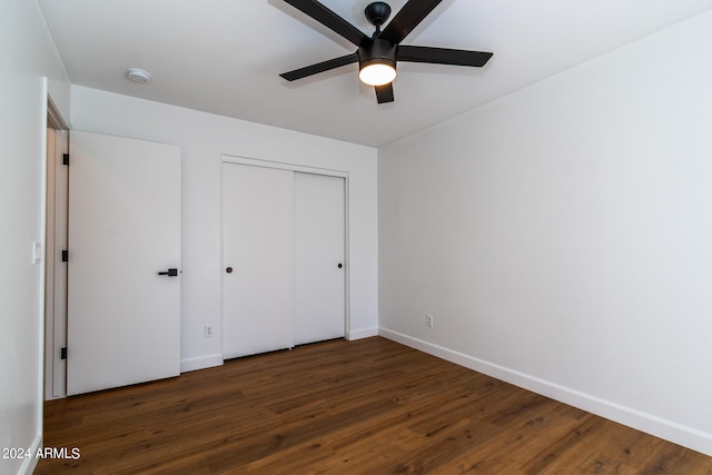 unfurnished bedroom featuring a closet, ceiling fan, and dark hardwood / wood-style flooring