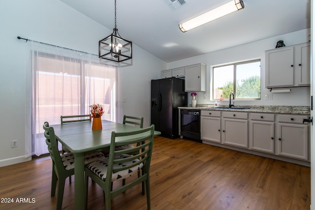 interior space featuring lofted ceiling, a chandelier, dark hardwood / wood-style flooring, and sink