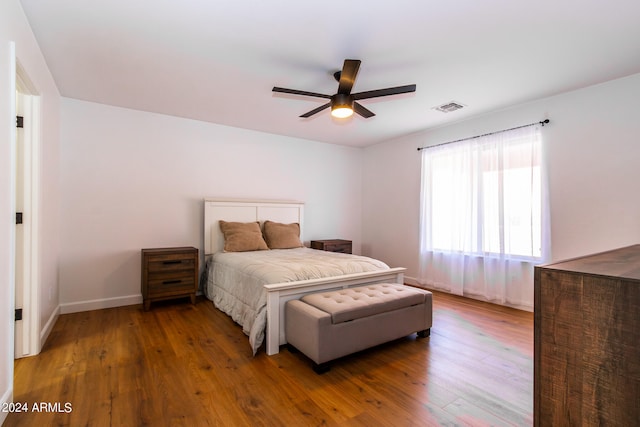 bedroom with ceiling fan and dark hardwood / wood-style floors