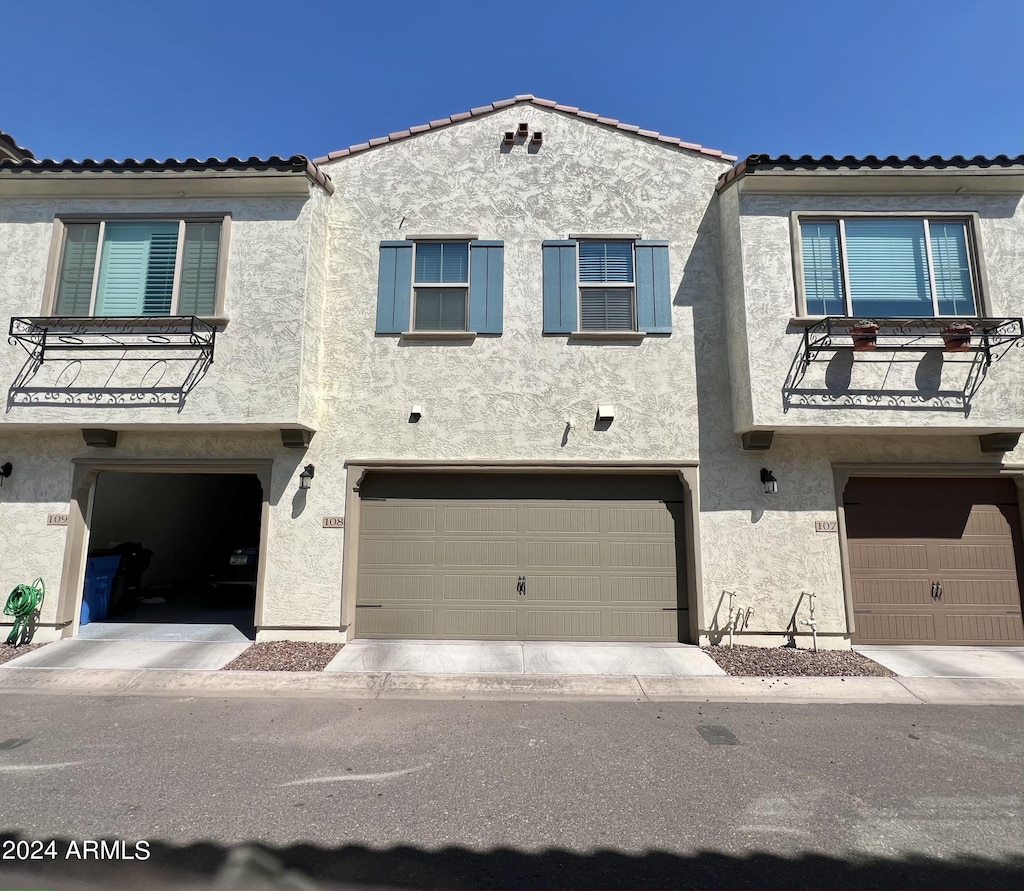 view of front of house with a balcony and a garage