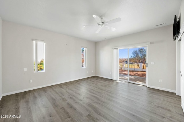 empty room with light hardwood / wood-style floors and ceiling fan