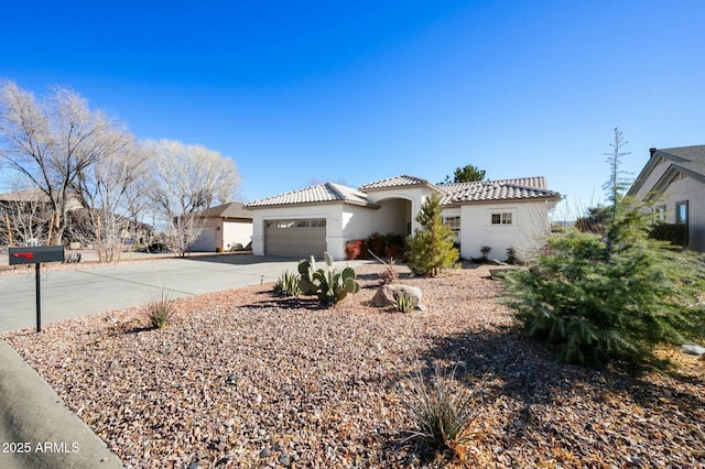 mediterranean / spanish home with a garage