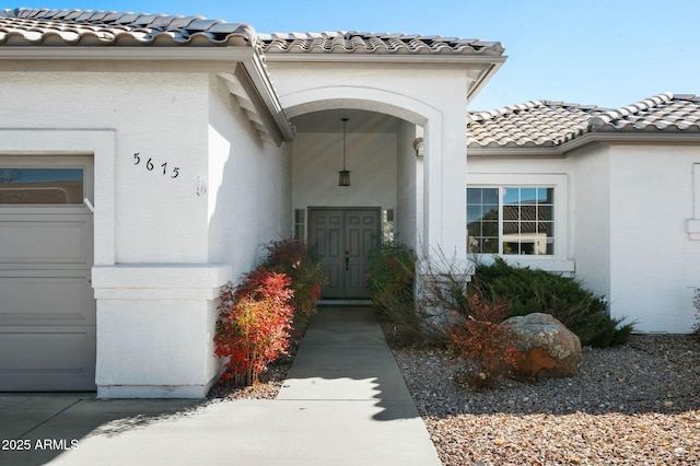 doorway to property with a garage