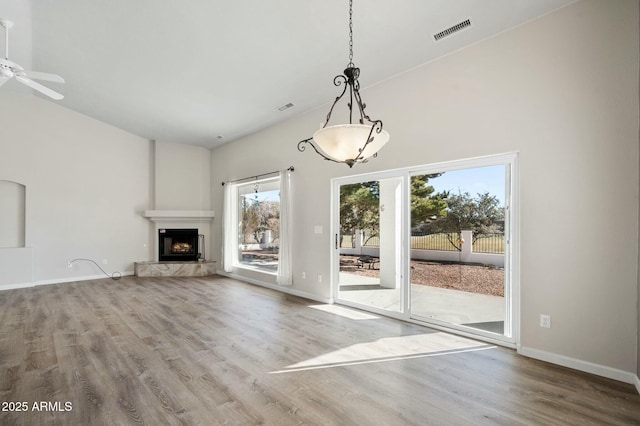 unfurnished living room featuring ceiling fan and hardwood / wood-style flooring