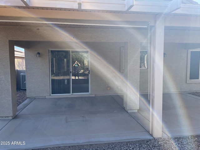 property entrance with a patio and central AC unit