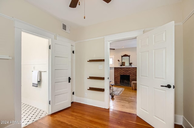 corridor with hardwood / wood-style flooring and baseboards