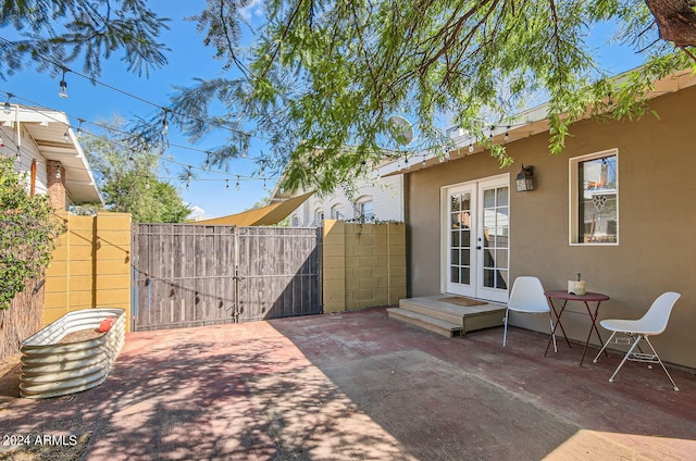 view of patio / terrace with french doors, fence, and a gate