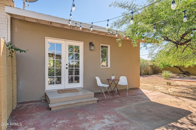rear view of house featuring french doors, stucco siding, a patio area, and fence