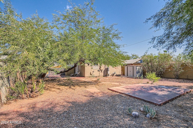 fenced backyard featuring a shed and an outbuilding