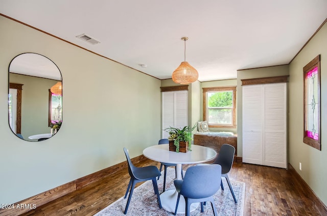 dining space featuring wood finished floors and baseboards